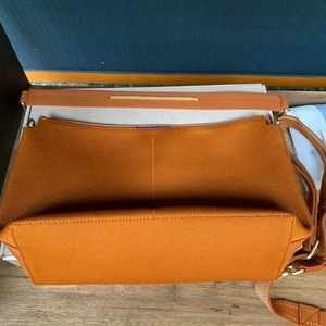 Hold Rothy’s daily everyday crossbody cognac